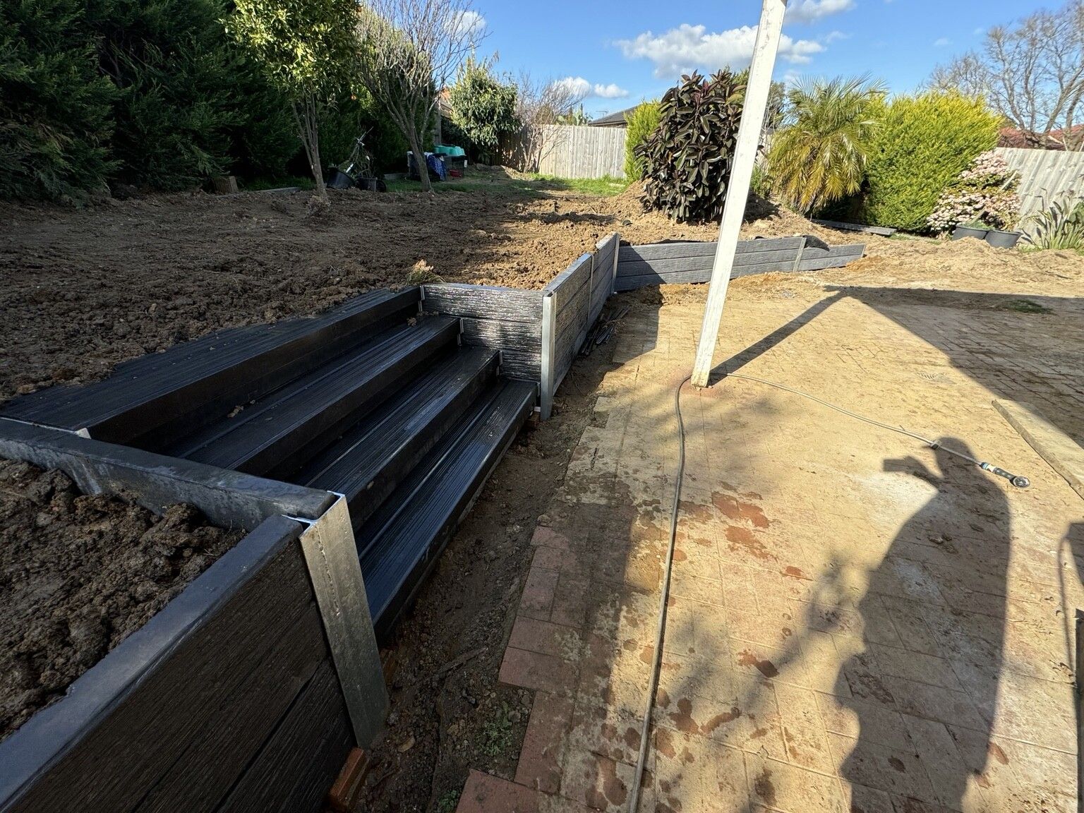 Berwick project: Concrete sleeper retaining wall with concrete sleepers, galvanised steel posts, integrated sleeper staircase. Photo 4 of 4.