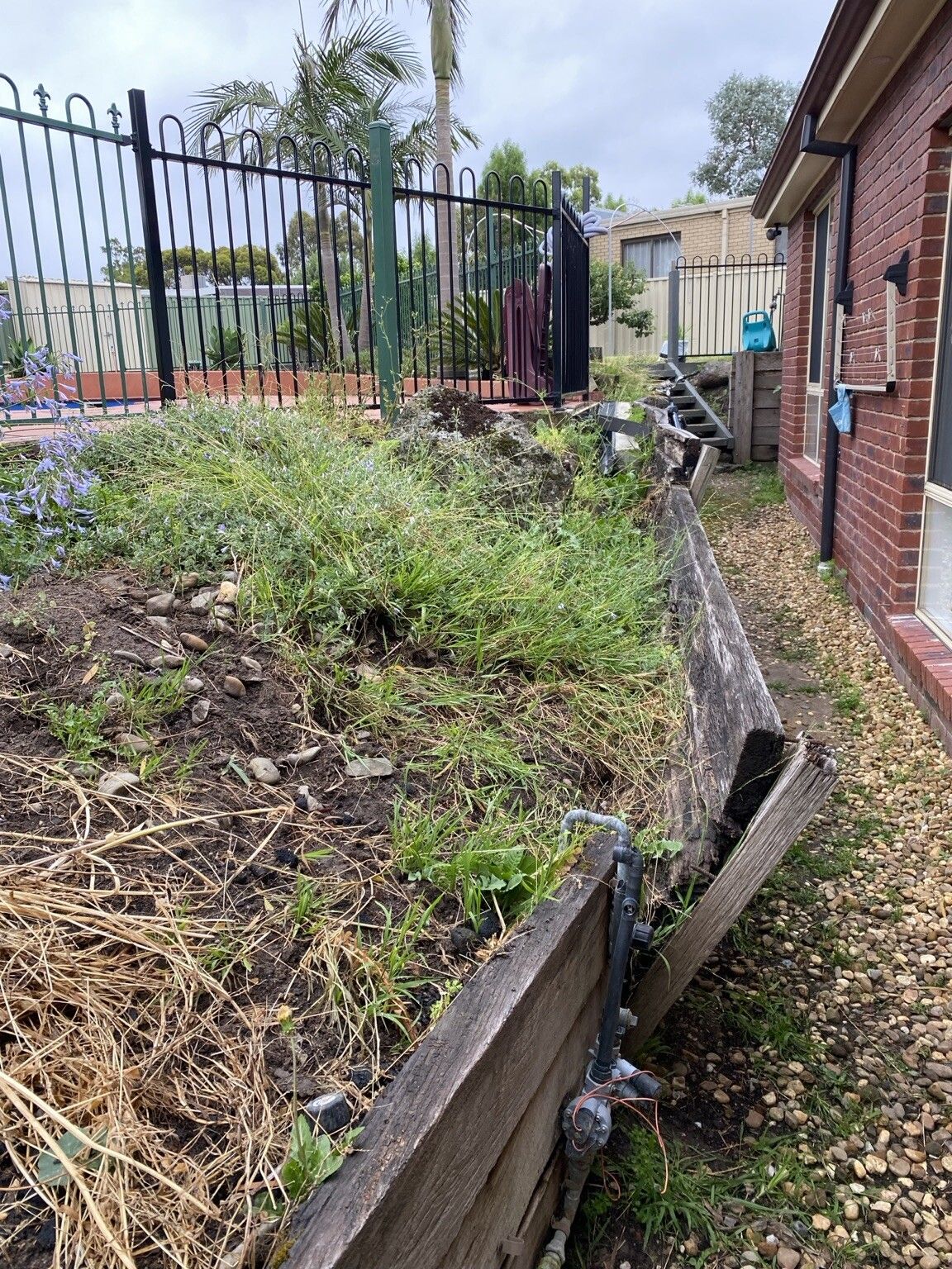 Endeavour Hills project: Concrete sleeper retaining wall with concrete sleepers, steel posts made to suit, access through the garage only. Photo 2 of 6.