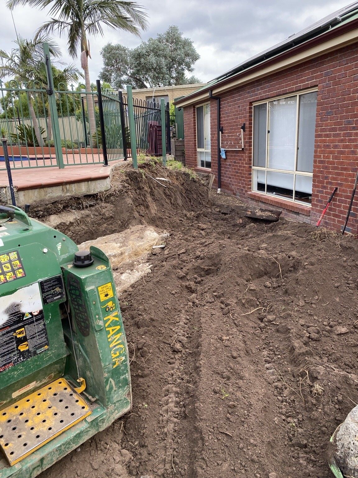 Endeavour Hills project: Concrete sleeper retaining wall with concrete sleepers, steel posts made to suit, access through the garage only. Photo 3 of 6.