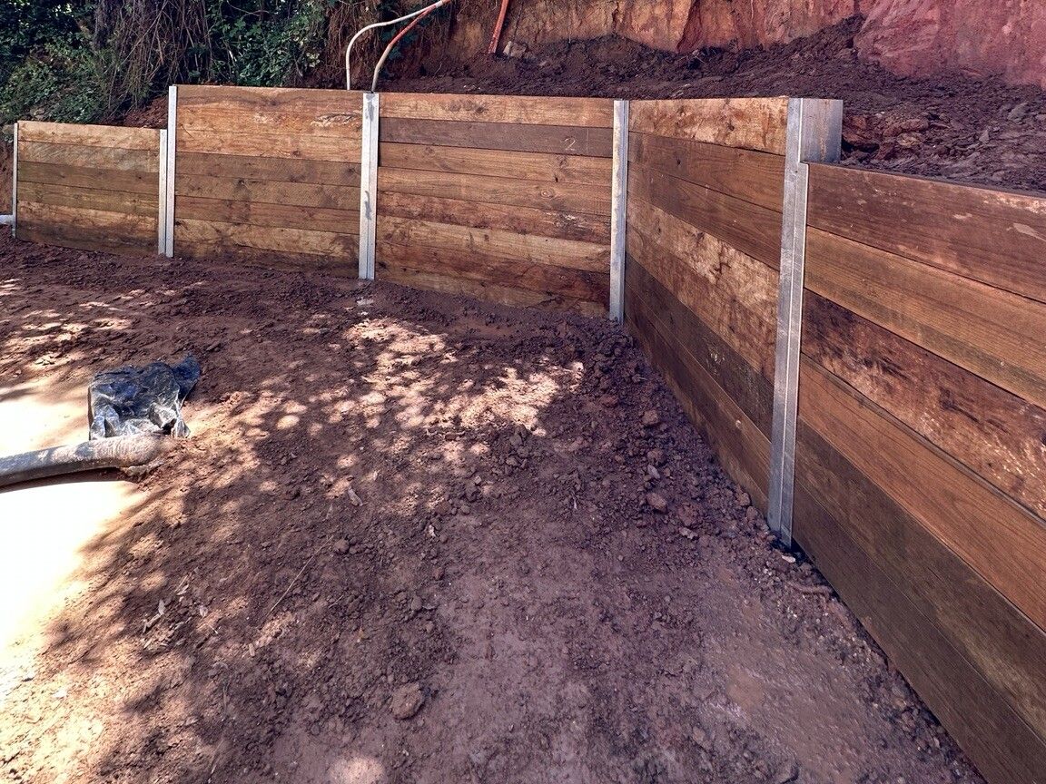 Ferny Creek project: Timber sleeper retaining wall with structural steel posts, stained timber sleepers, drainage to discharge points. Photo 1 of 5.