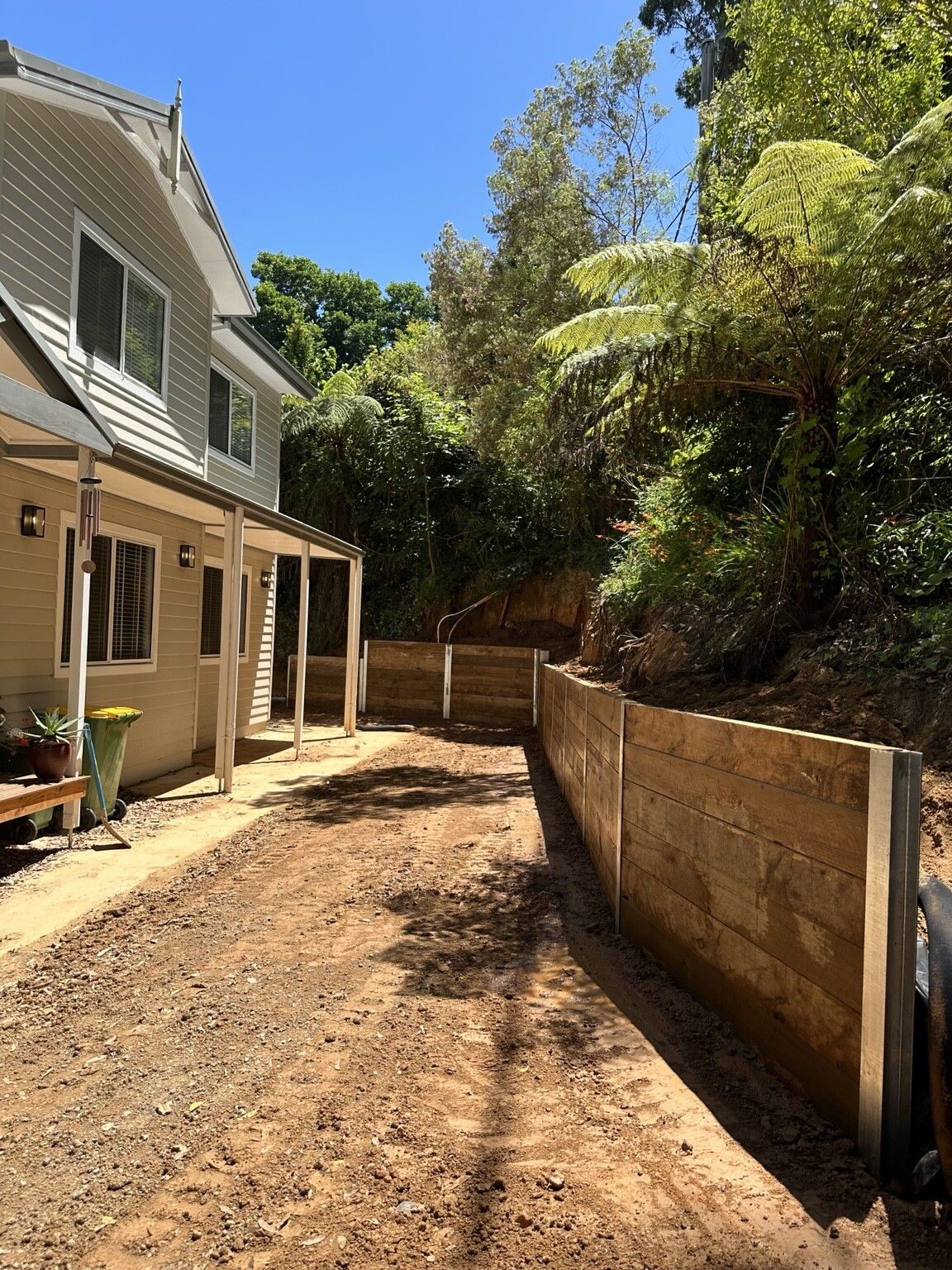Ferny Creek project: Timber sleeper retaining wall with structural steel posts, stained timber sleepers, drainage to discharge points. Photo 5 of 5.