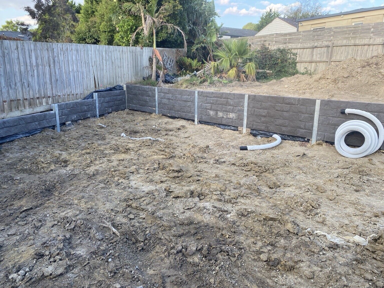 Frankston South project: Concrete sleeper retaining walls with concrete sleepers, galvanised steel posts, drainage, with a plumber. Photo 4 of 4.