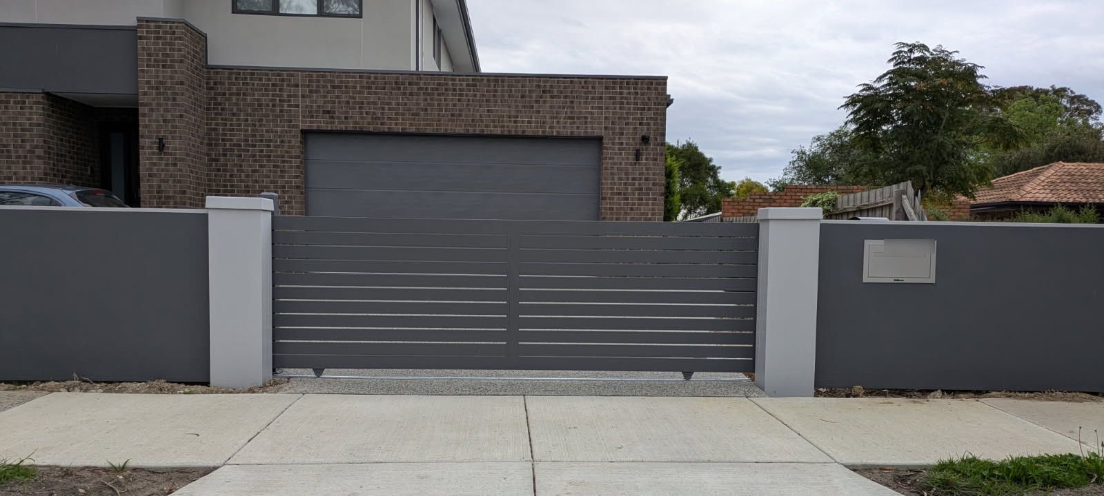 Glen Waverley gate project: Horizontal-slat sliding gate with horizontal-slat sliding gate, modular boundary walls, gate automation. Photo 1 of 1.