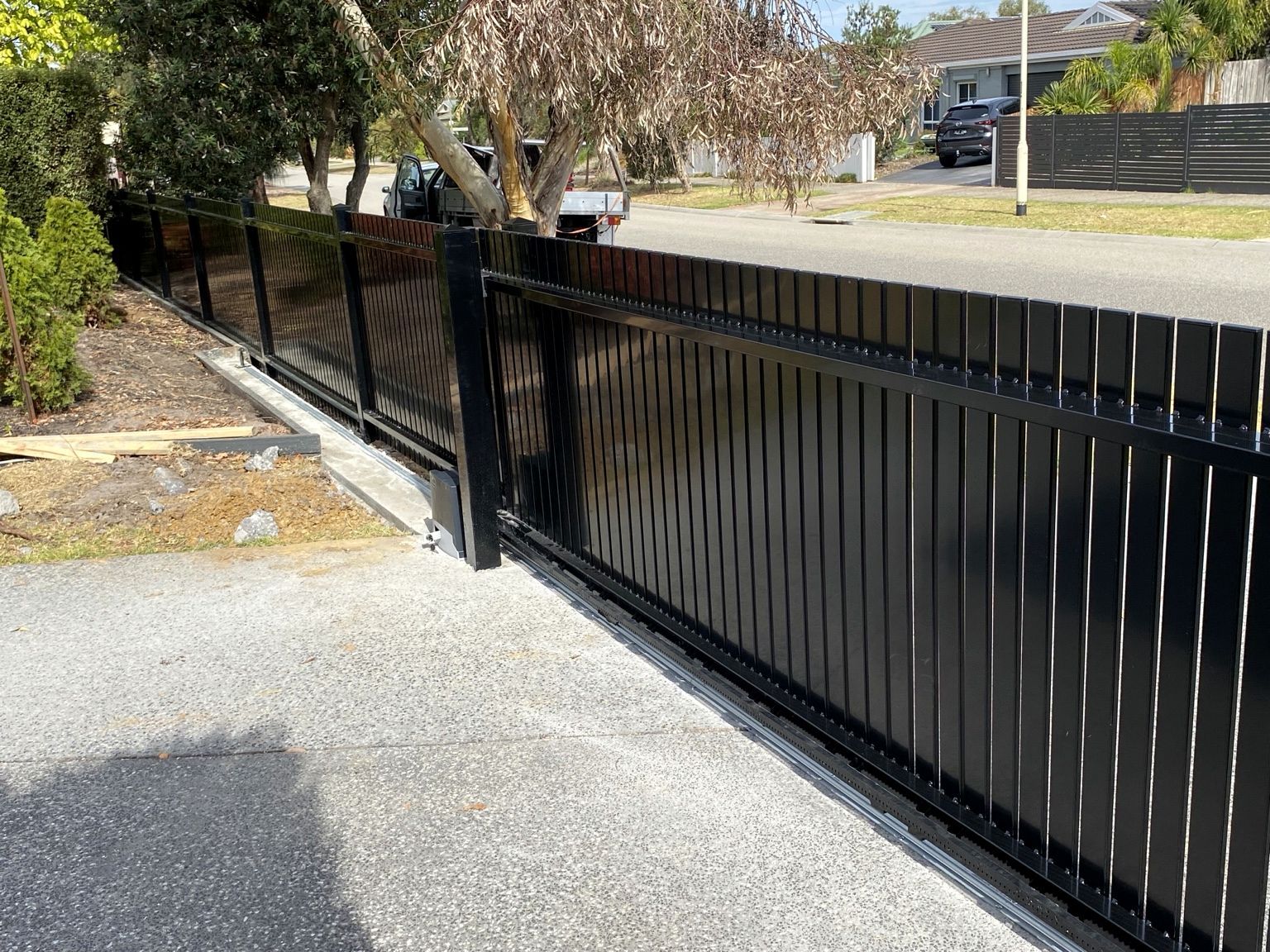 Black aluminium blade sliding gate across a driveway at Mornington.