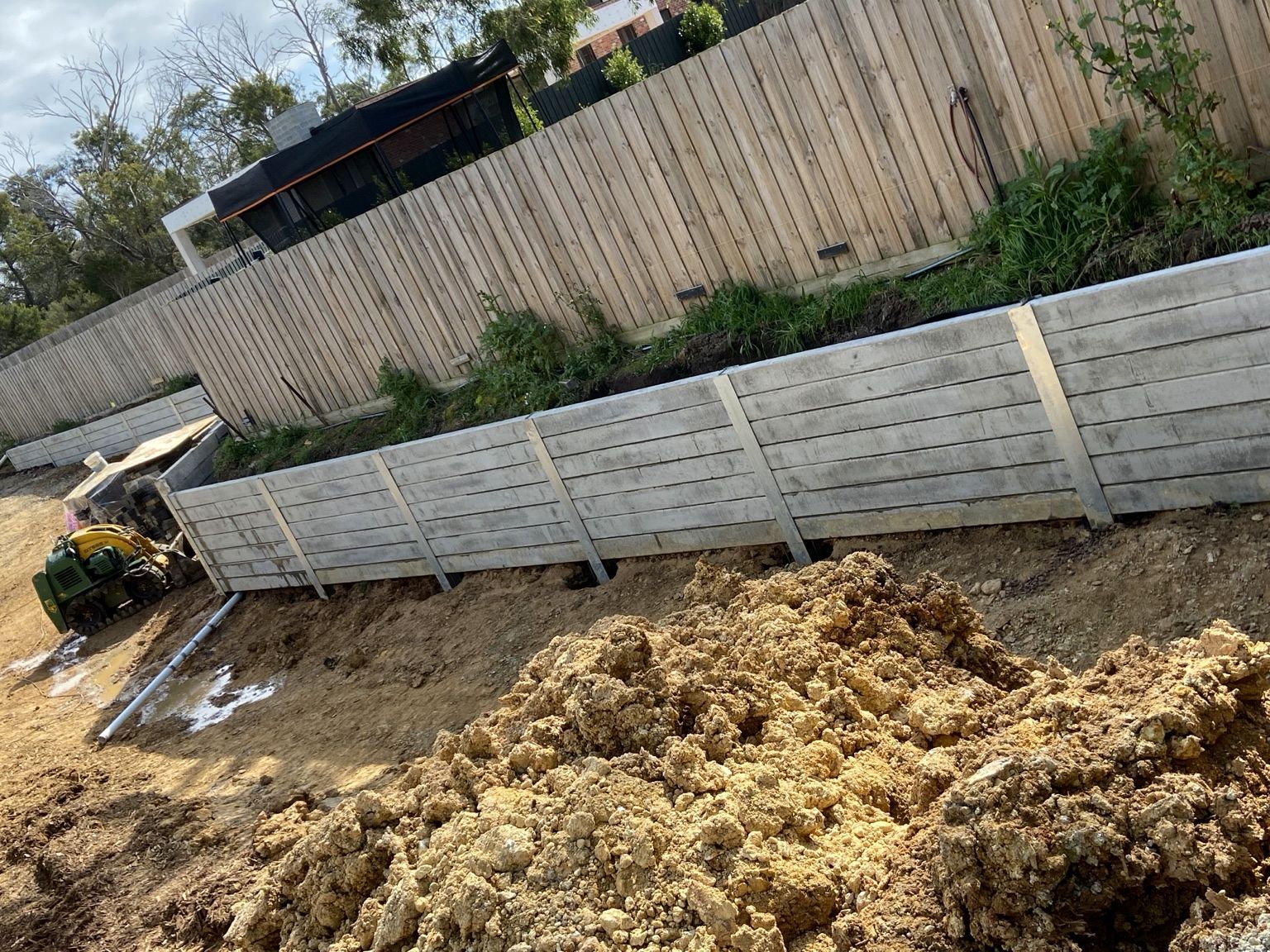 Mount Eliza project: Concrete sleeper retaining wall with heavy-duty concrete sleepers, uc125 steel posts, construction and progress photos. Photo 4 of 8.