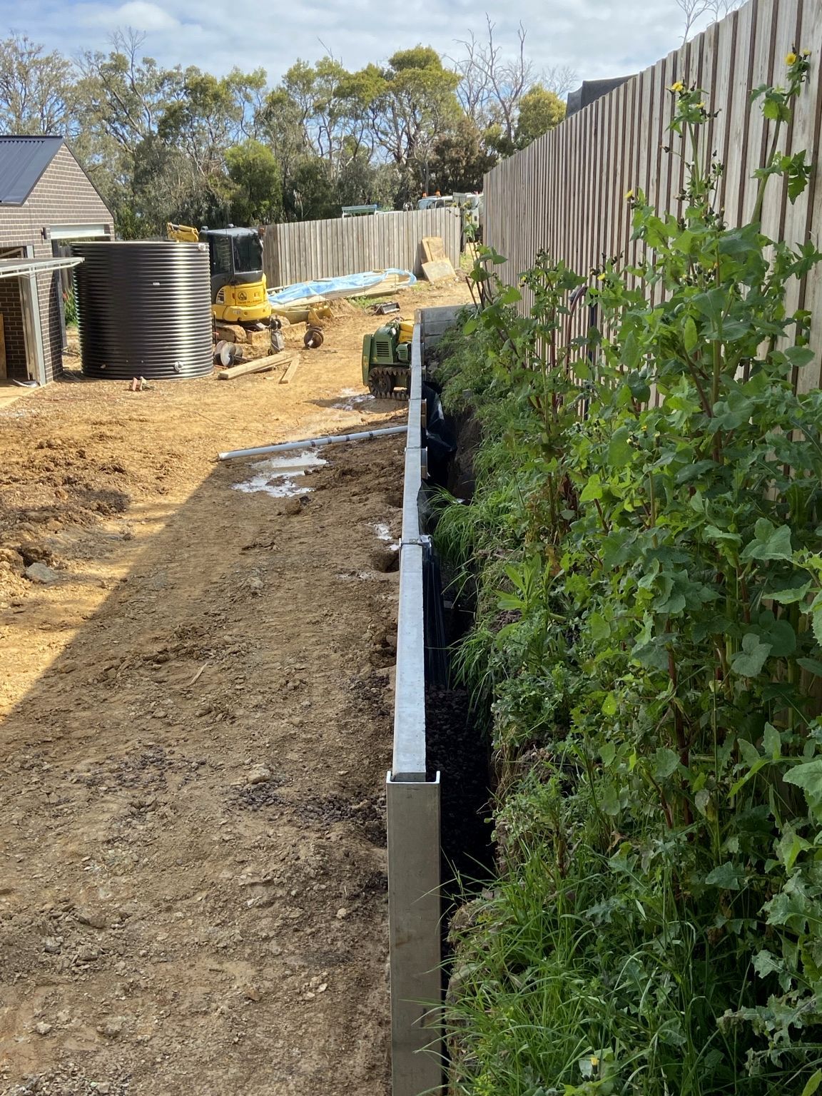 Looking along the top of the Mount Eliza wall during construction, between the sleepers and the garden bed.