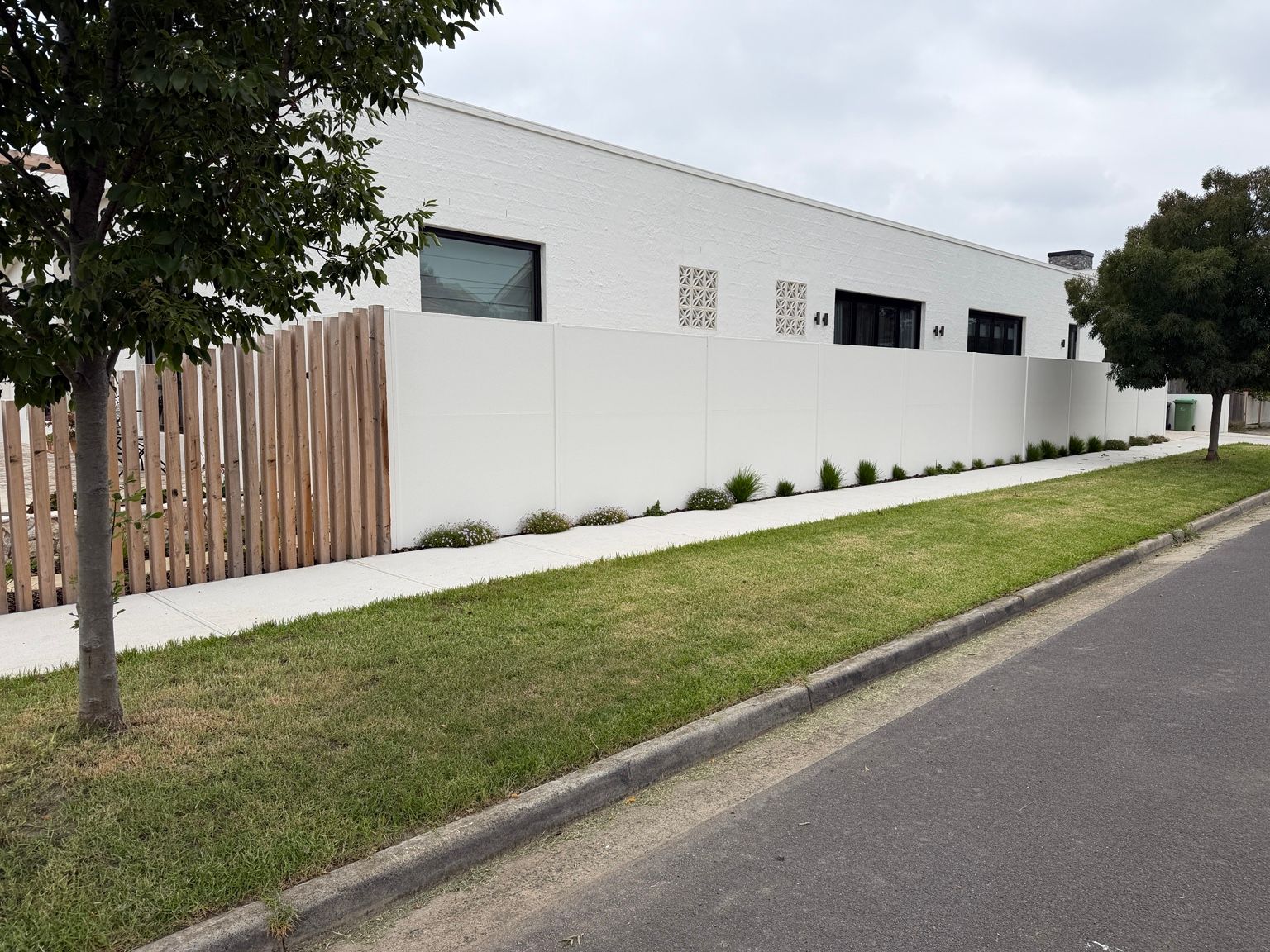 Reservoir project: SlimWall with integrated pedestrian gate, hardwood decorative sleepers, landscaped front boundary. Photo 4 of 5.